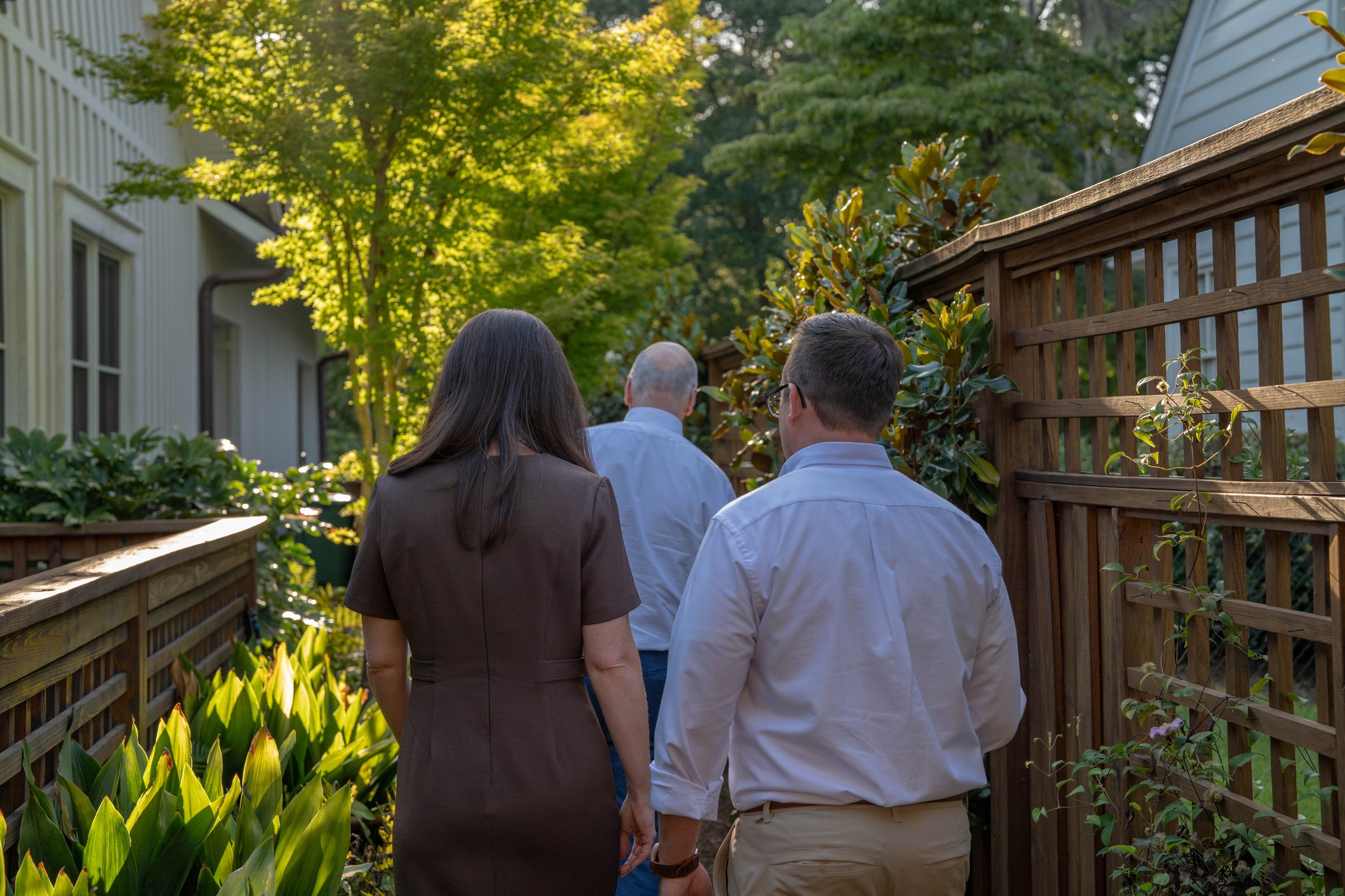 Caroline Toniolo, Wendell Jones and Rob Unger walking through a garden